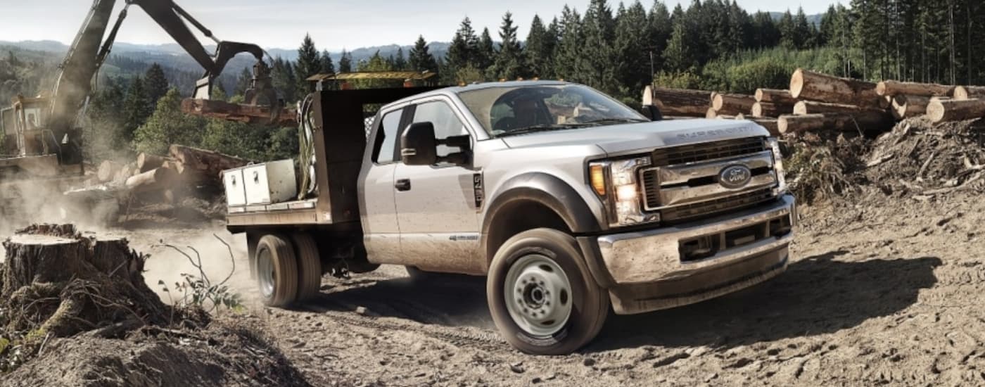 White 2018 Ford F-450 with a flatbed on a jobsite