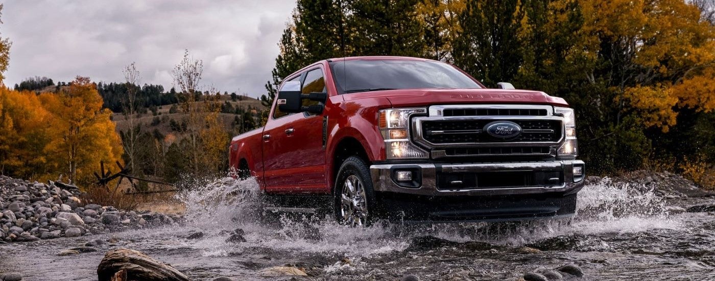 Red 2021 Ford F-250 Super Duty driving off-road
