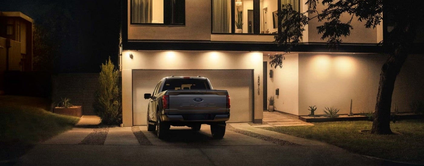 Rear of a grey 2025 Ford F-150 XL parked on a driveway.