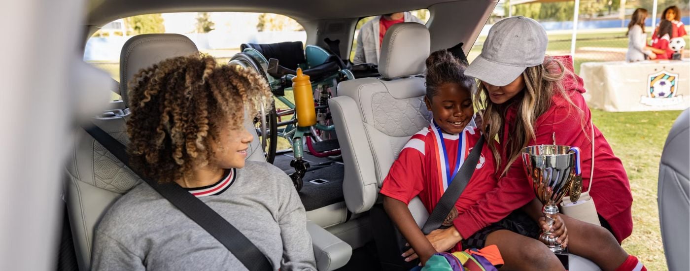 2026 Ford Explorer with loaded cargo and kids in the second row.