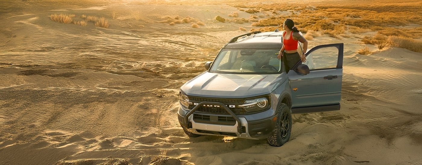 A blue 2026 Ford Bronco Sport Badlands parked off road.