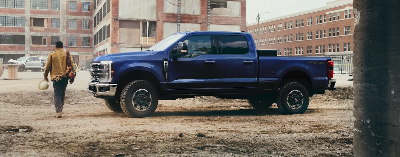 Side of a blue 2026 Ford F-350 Super Duty parked off-road.