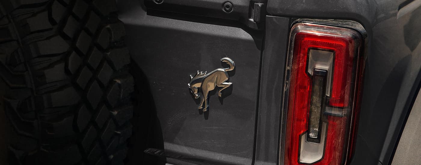 Bronco badge on the rear of a grey 2025 Ford Bronco at a Ford dealer near Midland