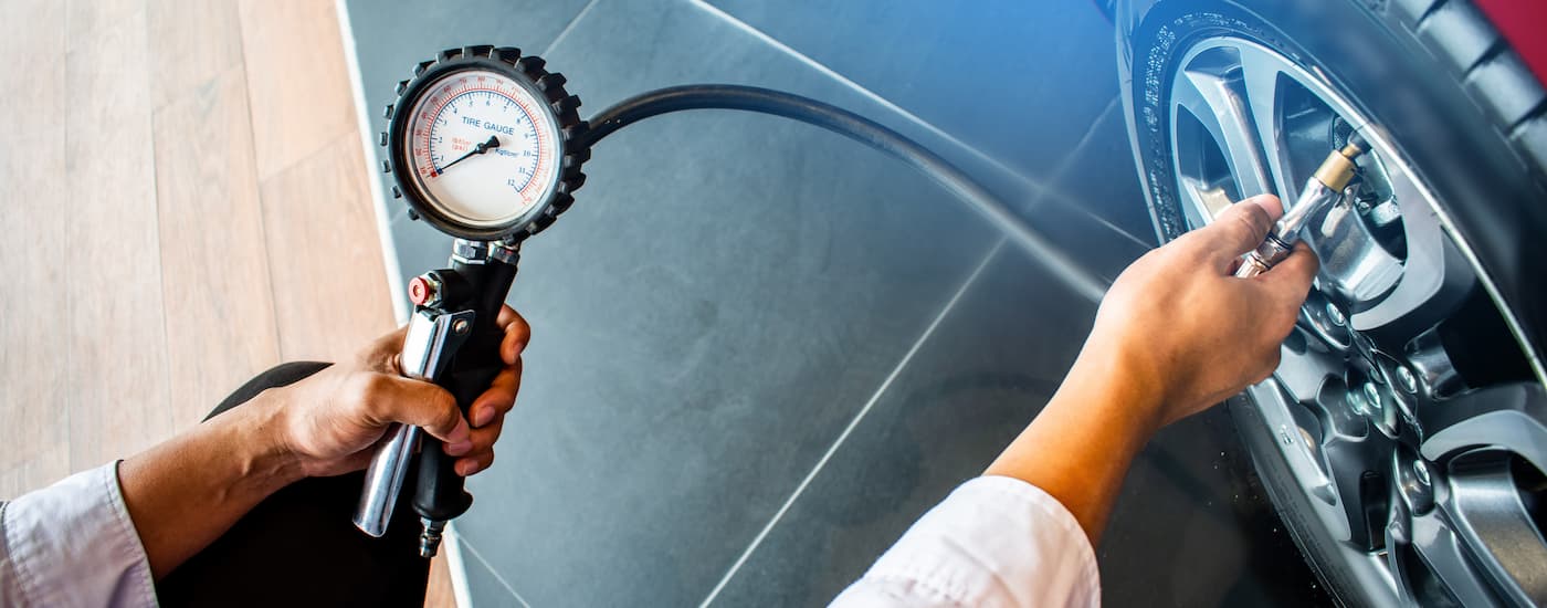 Mechanic checking a car's tire pressure