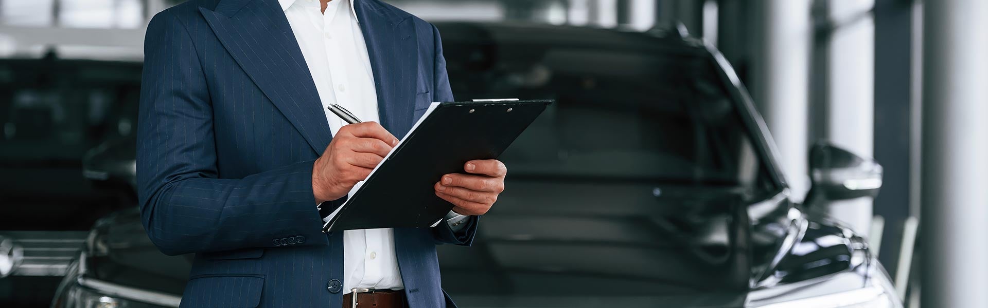 Salesperson Inspecting a Used Ford